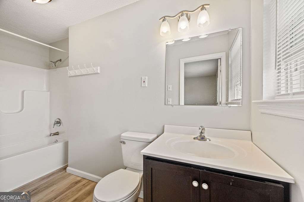 31 Jackson Way Fort Oglethorpe, GA 30742 - Photo 27 of 51 a bathroom with a sink vanity granite toilet and a mirror