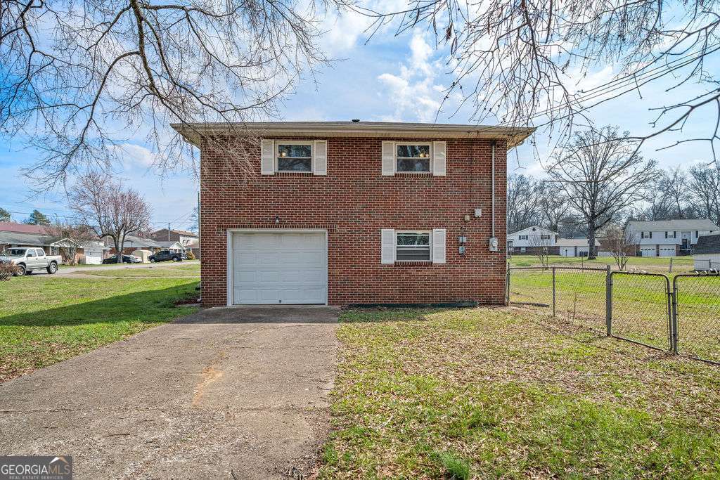 31 Jackson Way Fort Oglethorpe, GA 30742 - Photo 36 of 51 a brick house with a big yard and large trees