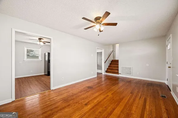 a view of a kitchen with a sink and a refrigerator