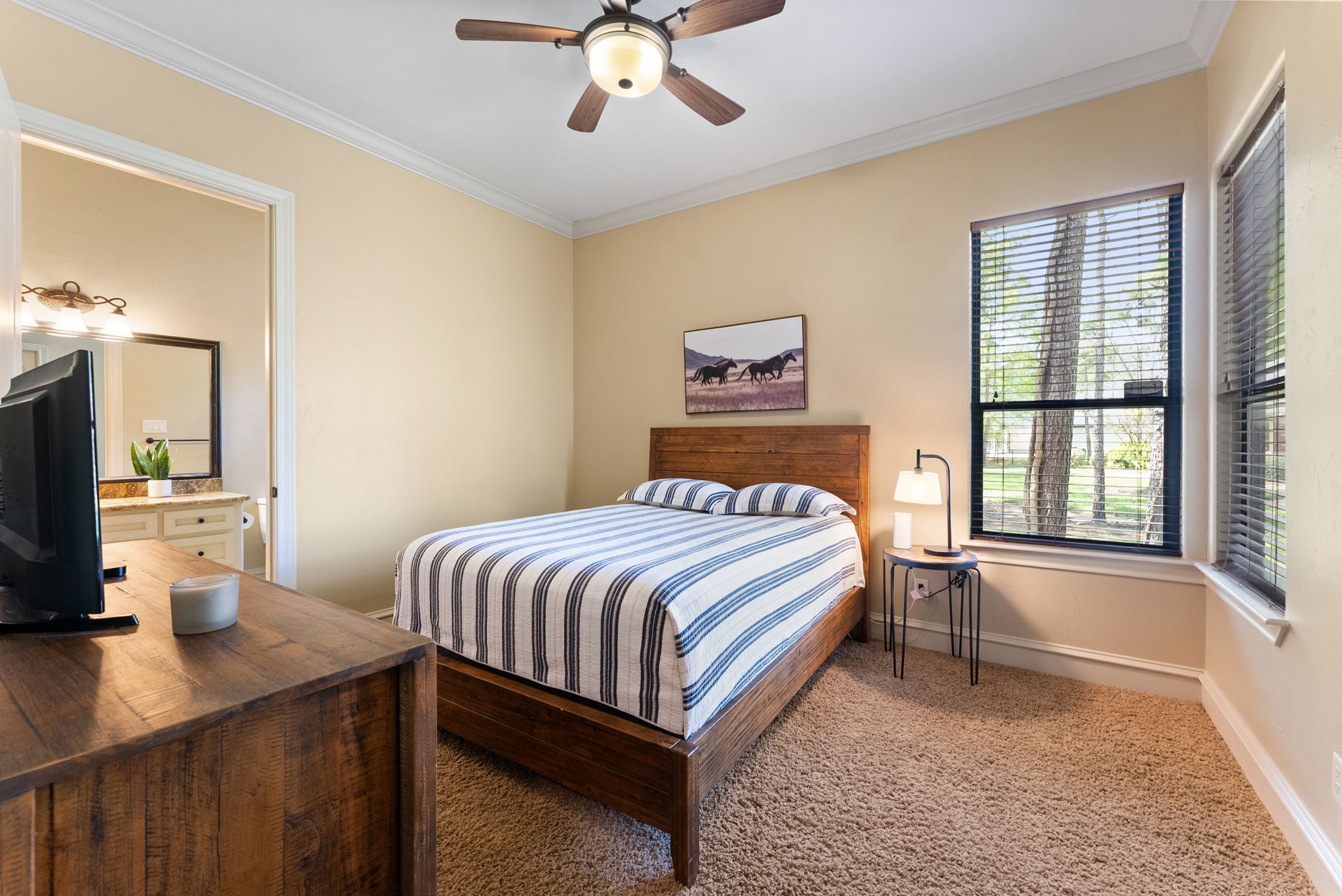 3907 Rayford Road Spring, TX 77386 - Photo 20 of 38 Privately located on the first floor, this Guest Bedroom features high ceilings, crown molding, a ceiling fan, corner windows for natural light, a large walk-in closet, and 3' wide doors.