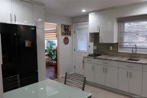 a kitchen with a sink a refrigerator and cabinets