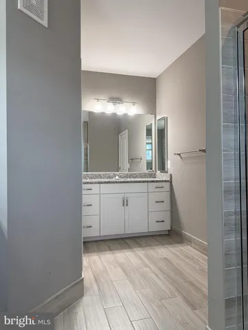 a bathroom with a double vanity sink and mirror