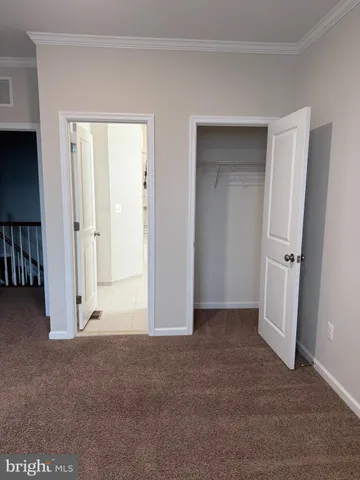 a front view of a house with plants and garden