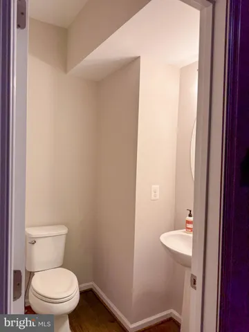 a white toilet sitting next to a bathroom sink