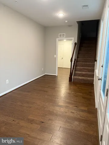 wooden floor in an empty room with stairs