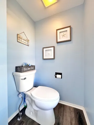 a white toilet sitting next to a bathroom sink