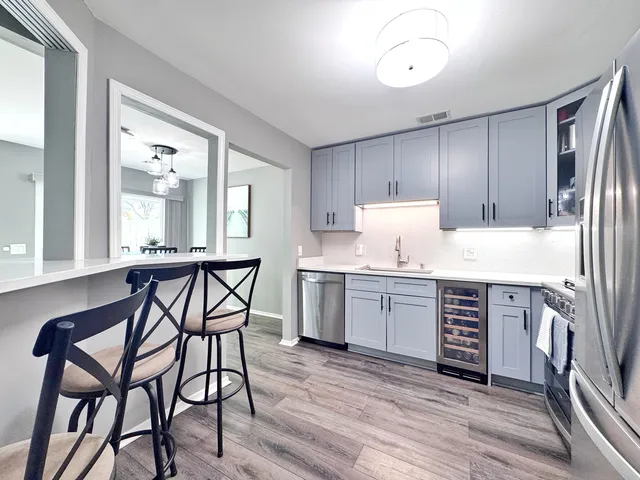 a kitchen with a table chairs sink and cabinets