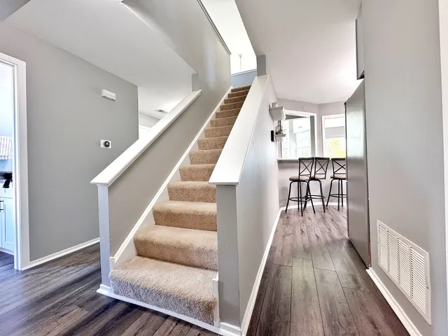 a view of entryway and hall with wooden floor