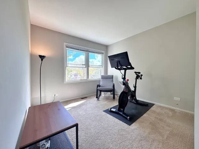 a room with gym equipment and a window