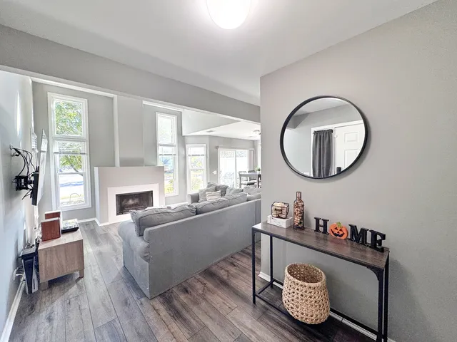 a living room with furniture and a mirror