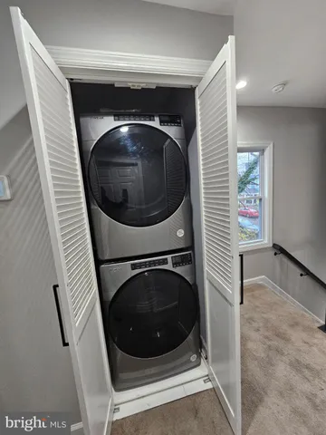 a view of a hallway with washer and dryer