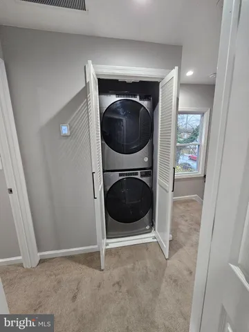 a view of a hallway with washer and dryer