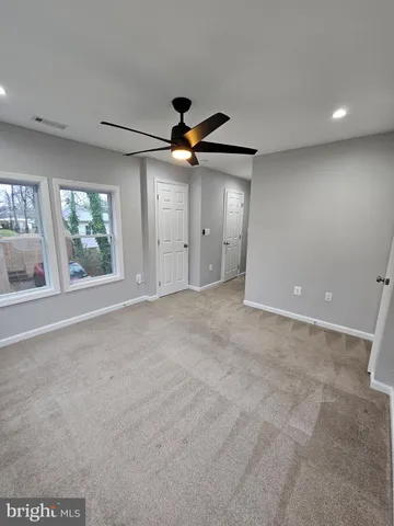a view of a livingroom with a ceiling fan and window