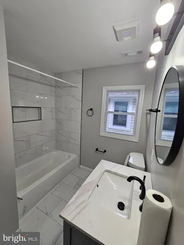 a bathroom with a sink a toilet and a bathtub