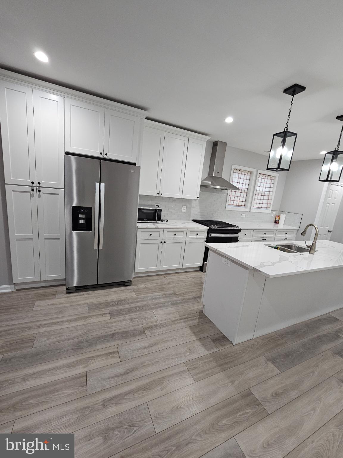 909 45th Place Northeast Washington, DC 20019 - Photo 29 of 36 a large kitchen with stainless steel appliances kitchen island granite countertop a stove a refrigerator a sink and a oven