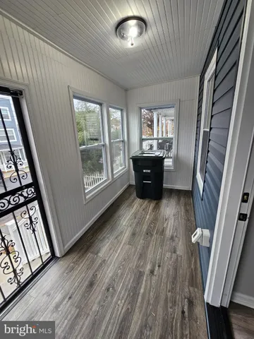 a view of a livingroom with wooden floor and furniture