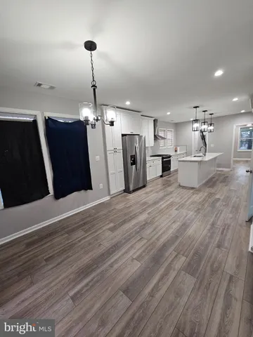 a view of a refrigerator in kitchen and wooden floor