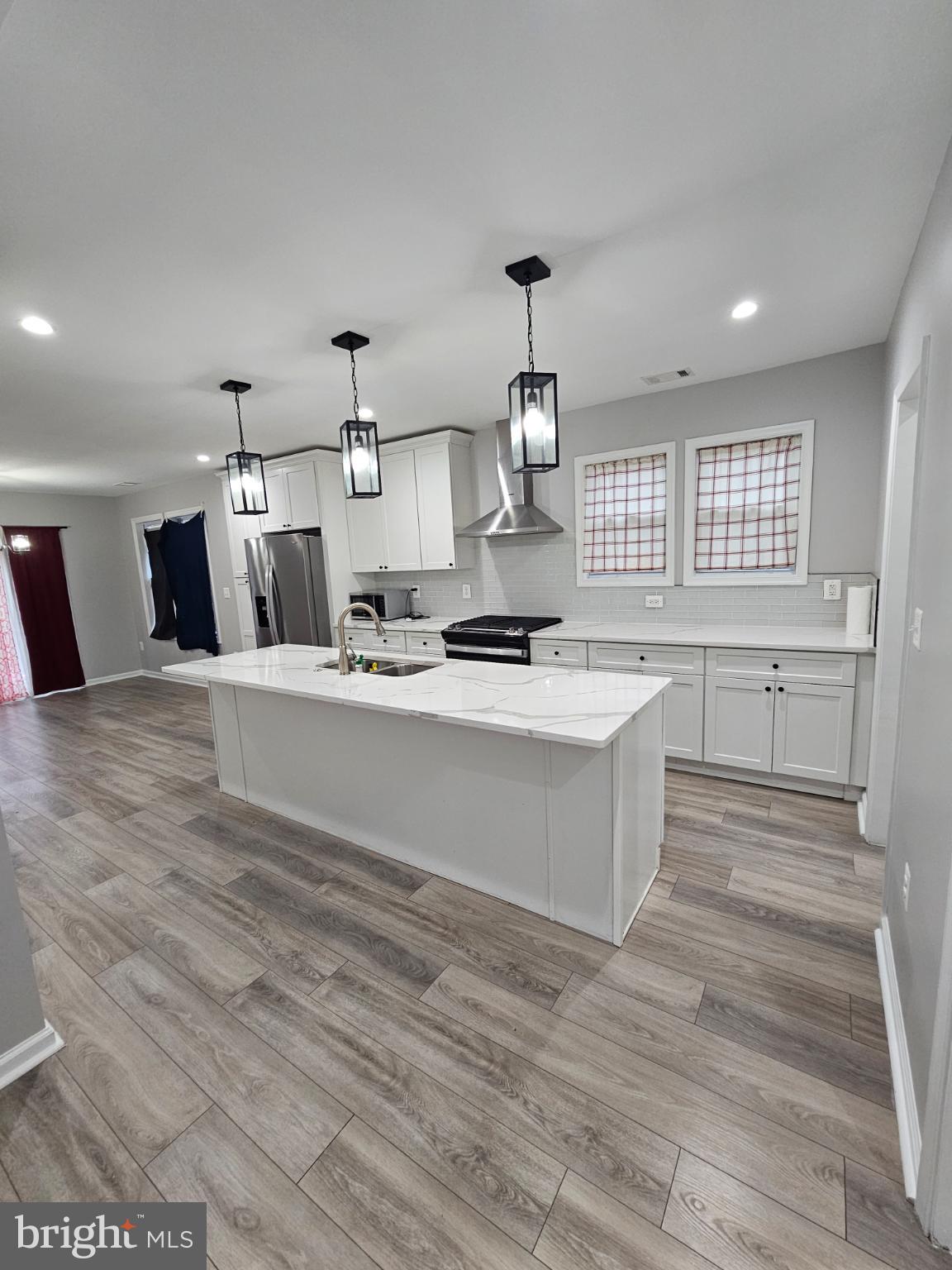 909 45th Place Northeast Washington, DC 20019 - Photo 34 of 36 a large white kitchen with kitchen island a sink stainless steel appliances and cabinets