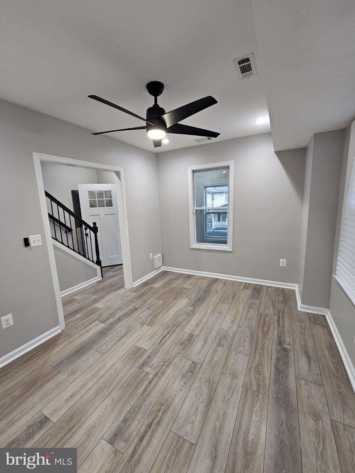909 45th Place Northeast Washington, DC 20019 - Photo 6 of 36 a view of an empty room with a window and wooden floor