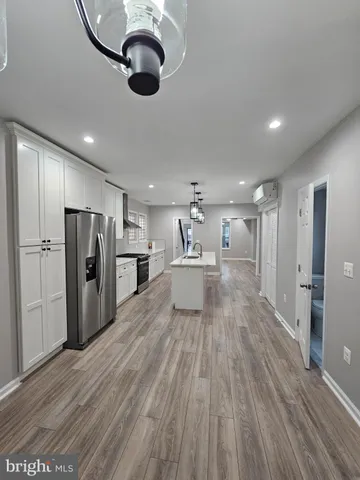 a view of kitchen with refrigerator microwave and wooden floor