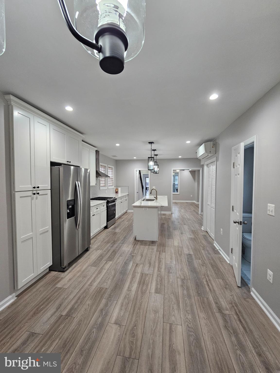 909 45th Place Northeast Washington, DC 20019 - Photo 8 of 36 a view of kitchen with refrigerator microwave and wooden floor