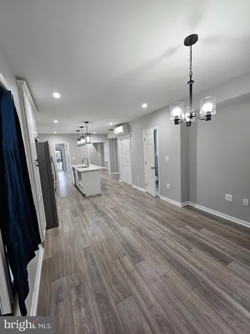 a view of a room with wooden floor and potted plant