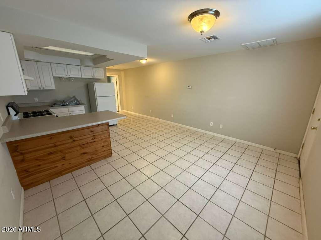 1810 East 8th Street, Unit C Douglas, AZ 85607 - Photo 3 of 14 a kitchen with stainless steel appliances a sink and a stove top oven