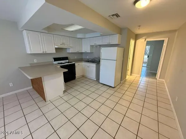 a kitchen with stainless steel appliances a refrigerator sink and cabinets