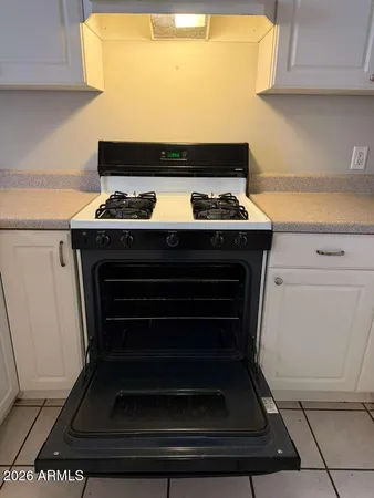a stove top oven sitting inside of a kitchen