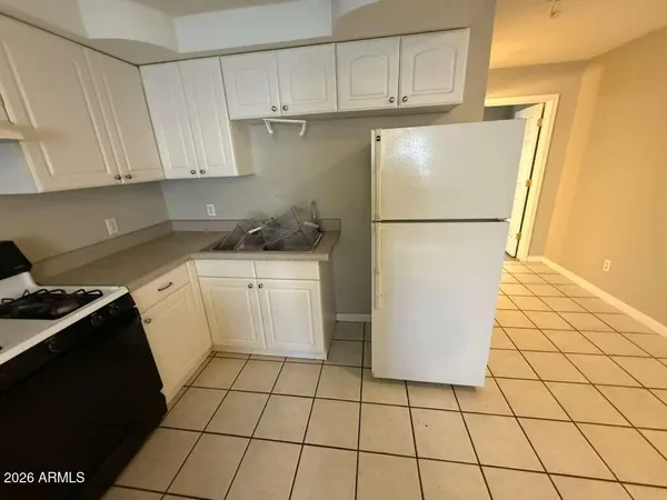 a kitchen with a white cabinets and white appliances