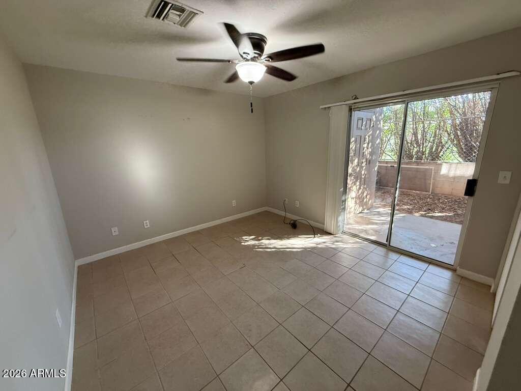 1810 East 8th Street, Unit C Douglas, AZ 85607 - Photo 9 of 14 an empty room with windows and ceiling fan