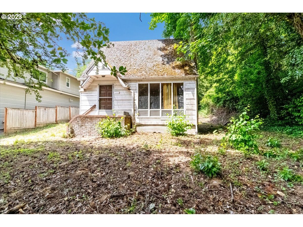 9429 Southwest View Point Terrace Portland, OR 97219 - Photo 3 of 12 a front view of a house with a yard and potted plants