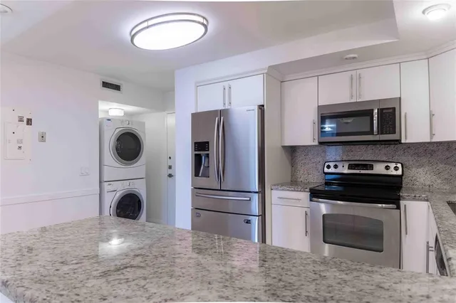 a kitchen with a refrigerator stove and microwave