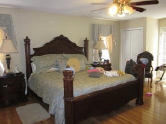 500 Normandy Tullahoma Road Normandy, TN 37360 - Photo 14 of 26 a bed sitting in a bedroom next to a window and a chandelier