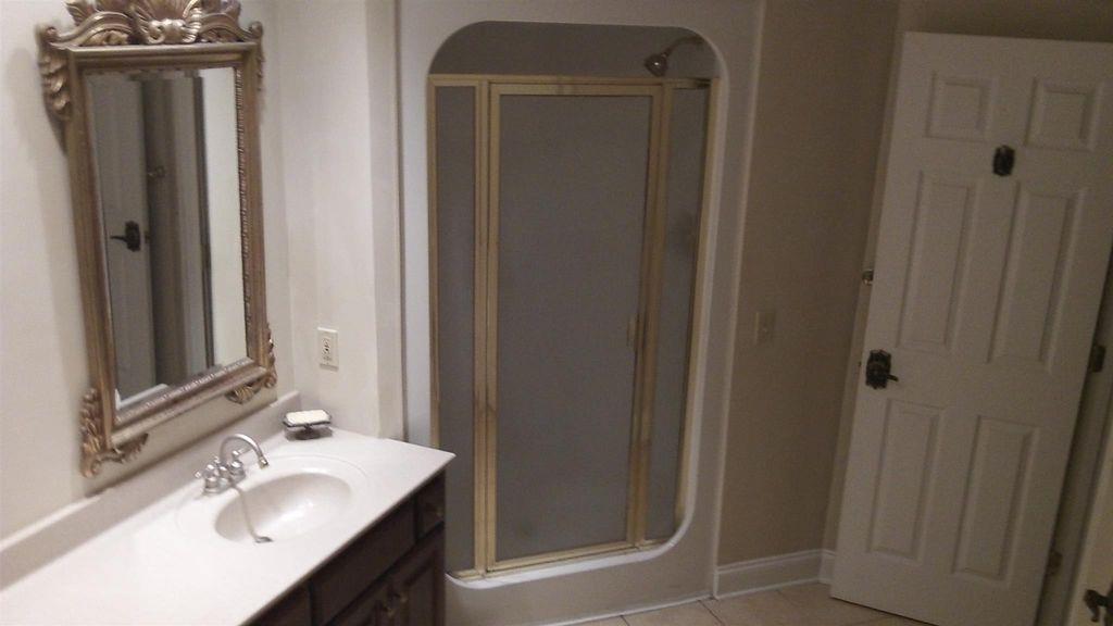 500 Normandy Tullahoma Road Normandy, TN 37360 - Photo 17 of 26 a bathroom with a sink a mirror and a shower