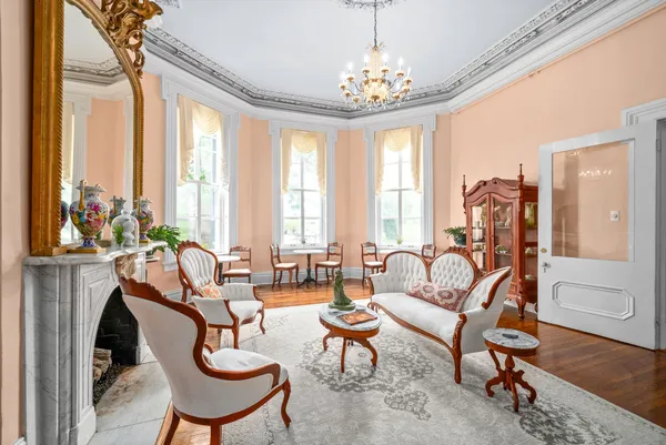 a living room with furniture a rug and a fireplace