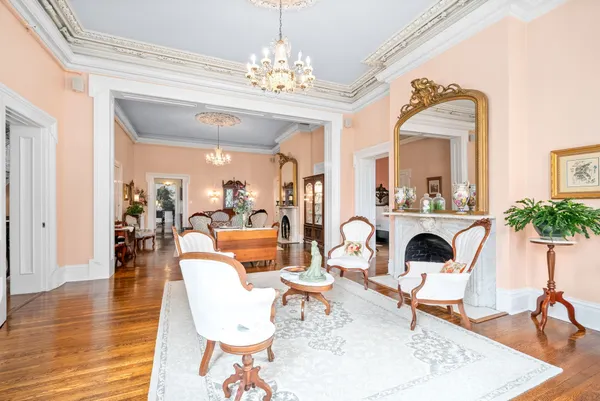 a living room with furniture a fireplace and a floor to ceiling window