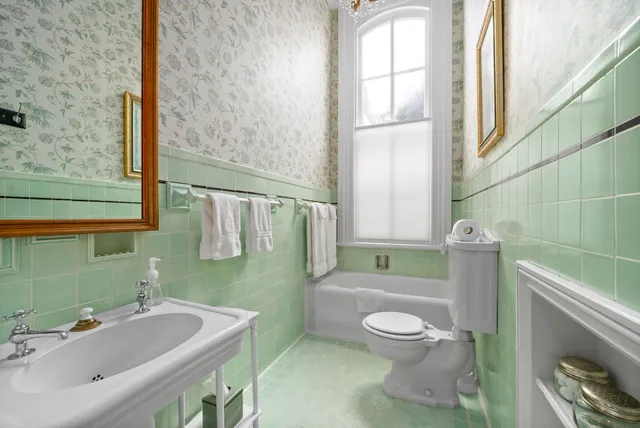 a bedroom with a bed and a potted plant