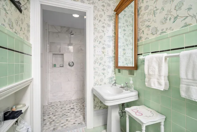 a bathroom with a sink toilet and a mirror