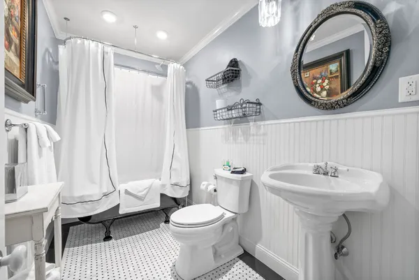 a spacious bedroom with a bed and a flat screen tv