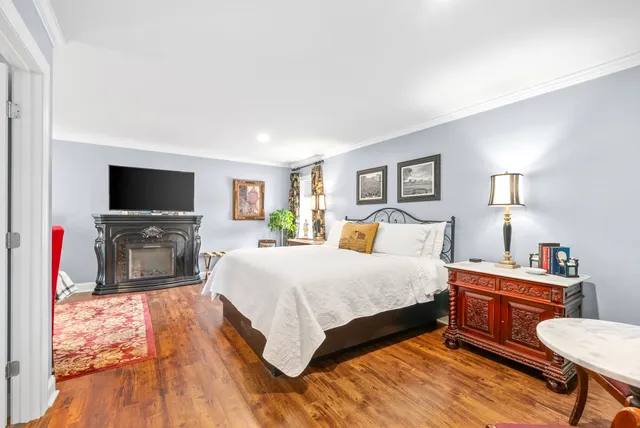 a bathroom with a sink a toilet a mirror and shower