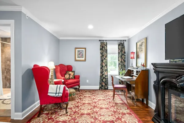 a bedroom with a bed a flat screen tv and balcony view