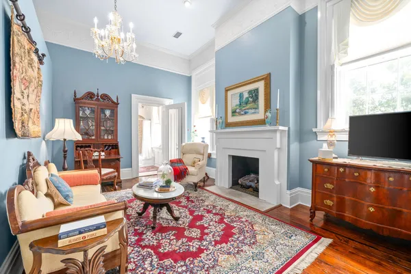 a bedroom with bed and wooden floor