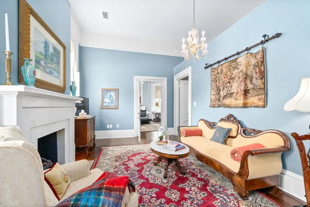 a living room with furniture a flat screen tv and a fireplace