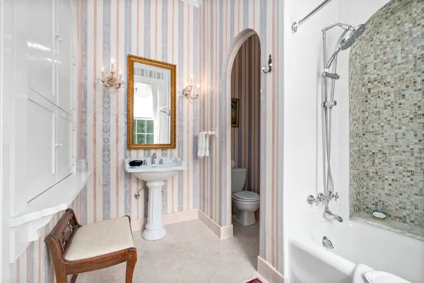 a dining hall with a dining table and chairs with the kitchen view