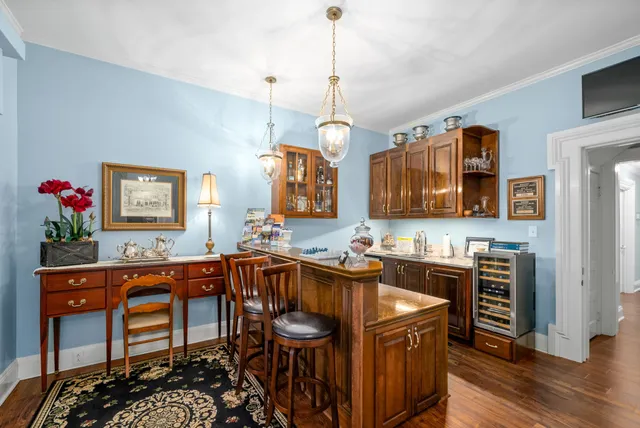 a kitchen that has a lot of cabinets in it and wooden floors