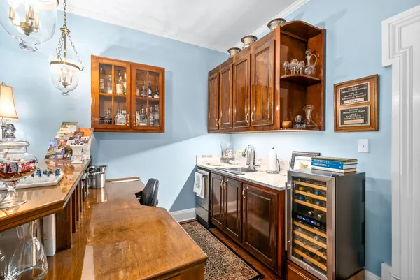 a kitchen with a stove a refrigerator and wooden floor