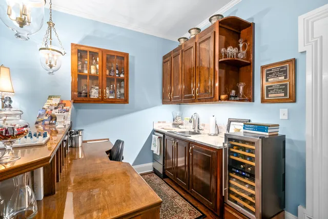 a kitchen with a stove a refrigerator and wooden floor