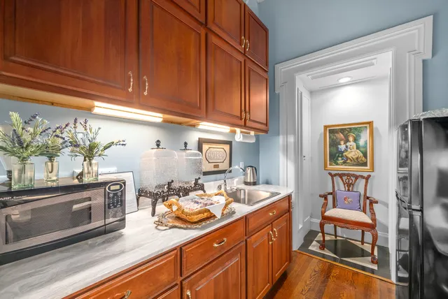 a living room with fireplace furniture and a chandelier