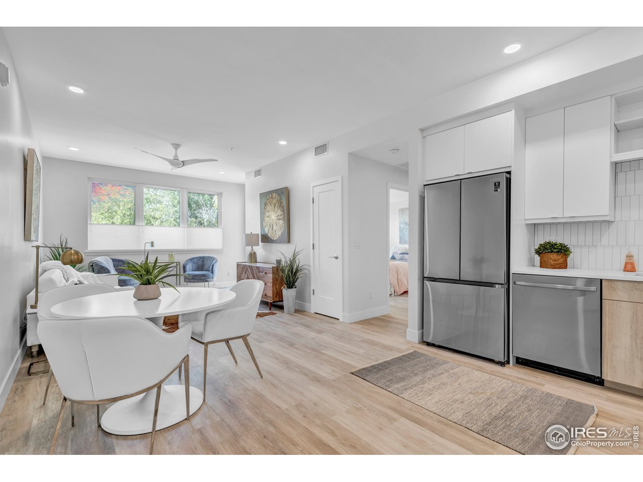 3261 Airport Road, Unit 204 Boulder, CO 80301 - Photo 1 of 36 a living room with furniture a window and wooden floors